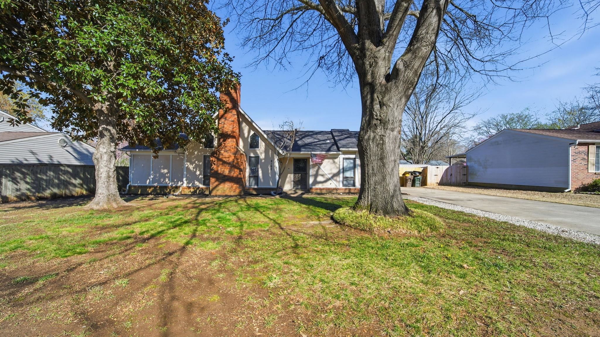 4182 Luther Road Bartlett, TN 38135 - Photo 5 of 40 a yellow house with trees in front of it