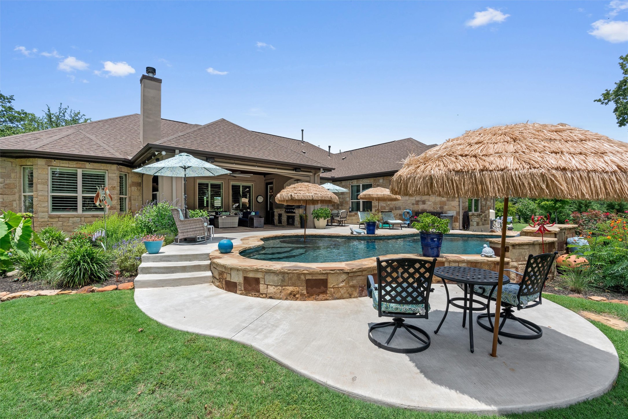 104 Adobe Cove Georgetown, TX 78633 - Photo 33 of 40 An inviting backyard oasis offers a sparkling pool and plenty of lounging space for outdoor enjoyment.