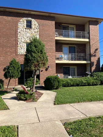 a front view of building with yard