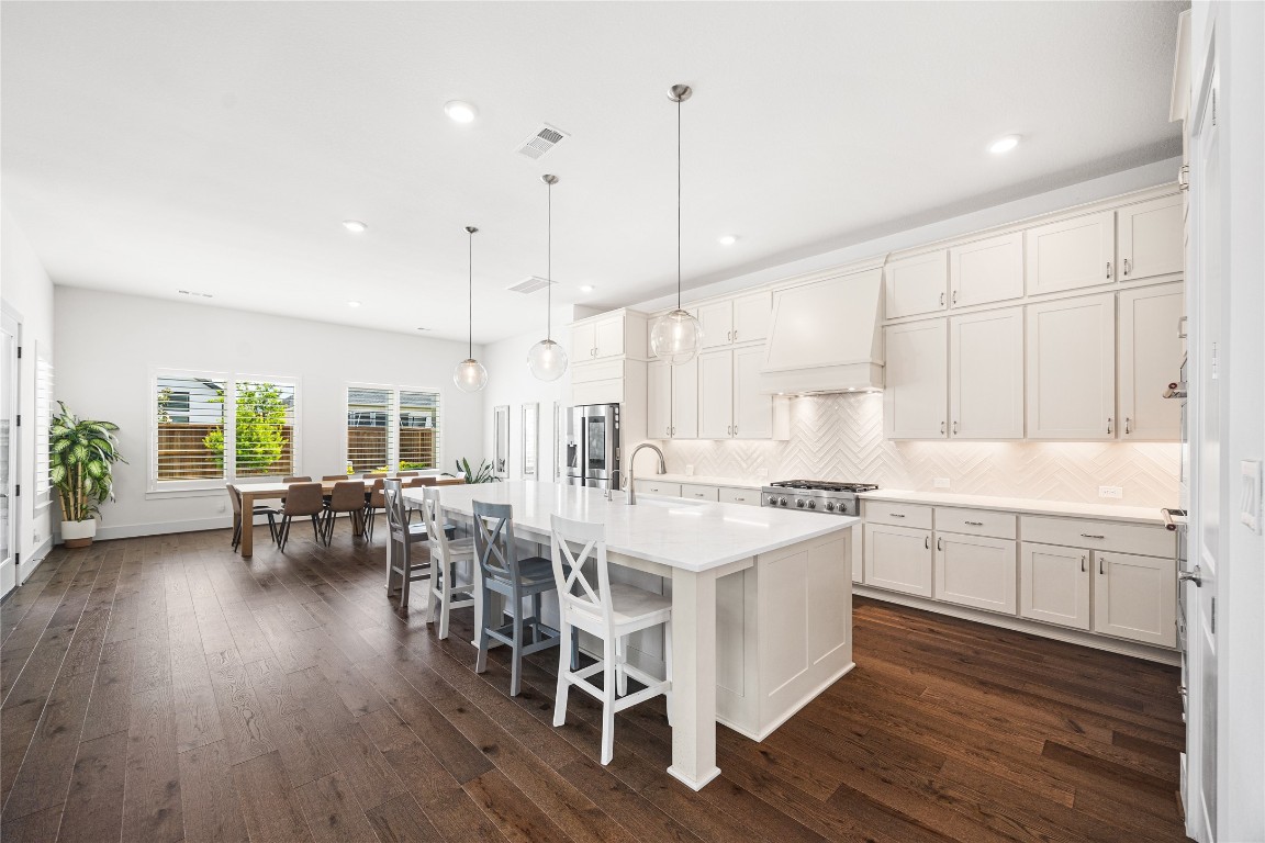 4114 Pleasant Ridge Drive Spring, TX 77386 - Photo 12 of 48 Kitchen-dining area centered around an oversized island, creating the perfect hub for gathering, casual dining, and entertaining.
