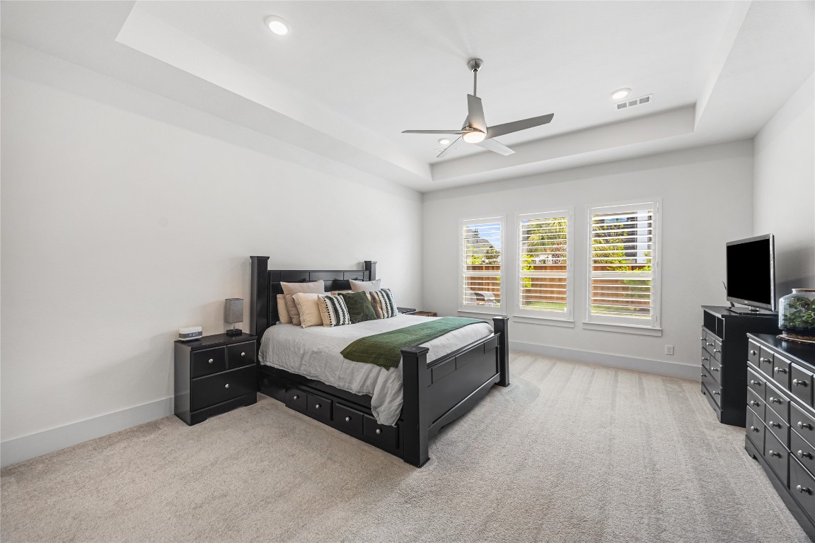 4114 Pleasant Ridge Drive Spring, TX 77386 - Photo 19 of 48 Oversized primary bedroom filled with natural light from large windows, offering a spacious and serene retreat.