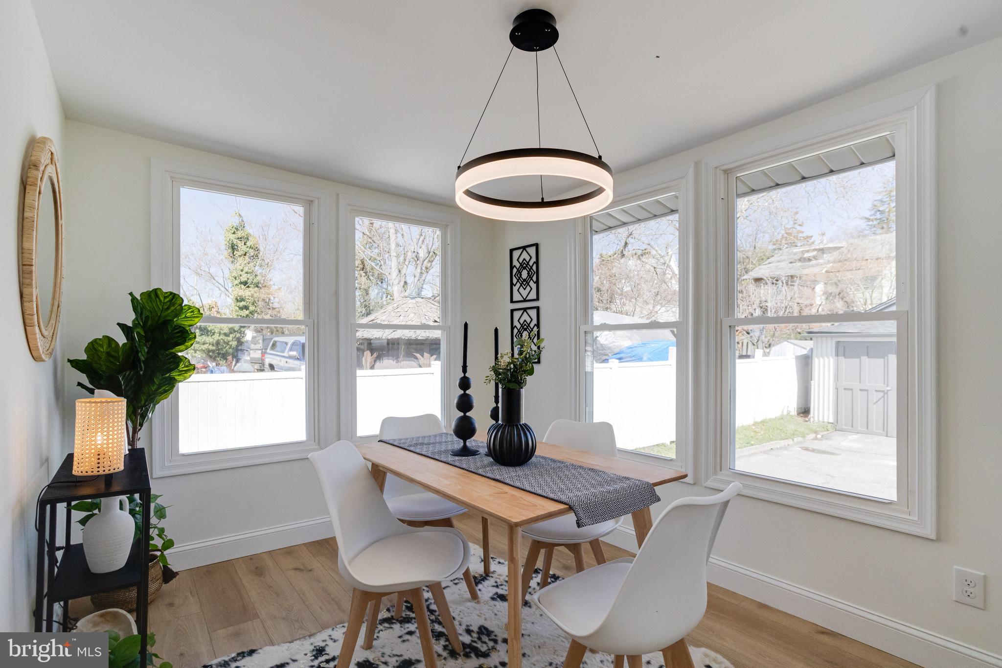 1729 Winans Avenue Halethorpe, MD 21227 - Photo 11 of 40 a dining room with furniture potted plants and wooden floor