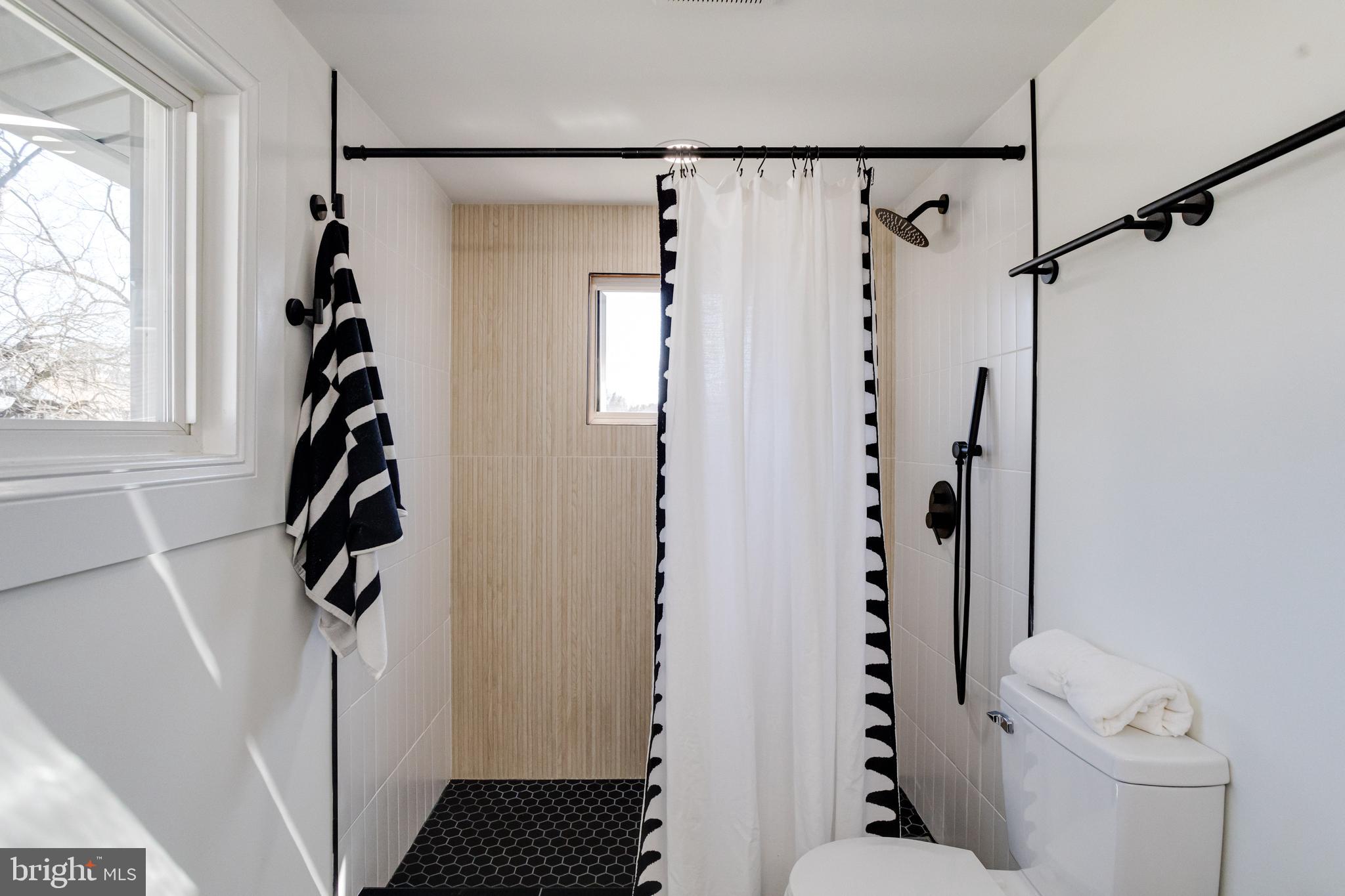 1729 Winans Avenue Halethorpe, MD 21227 - Photo 22 of 40 a view of a bathroom with a shower curtain