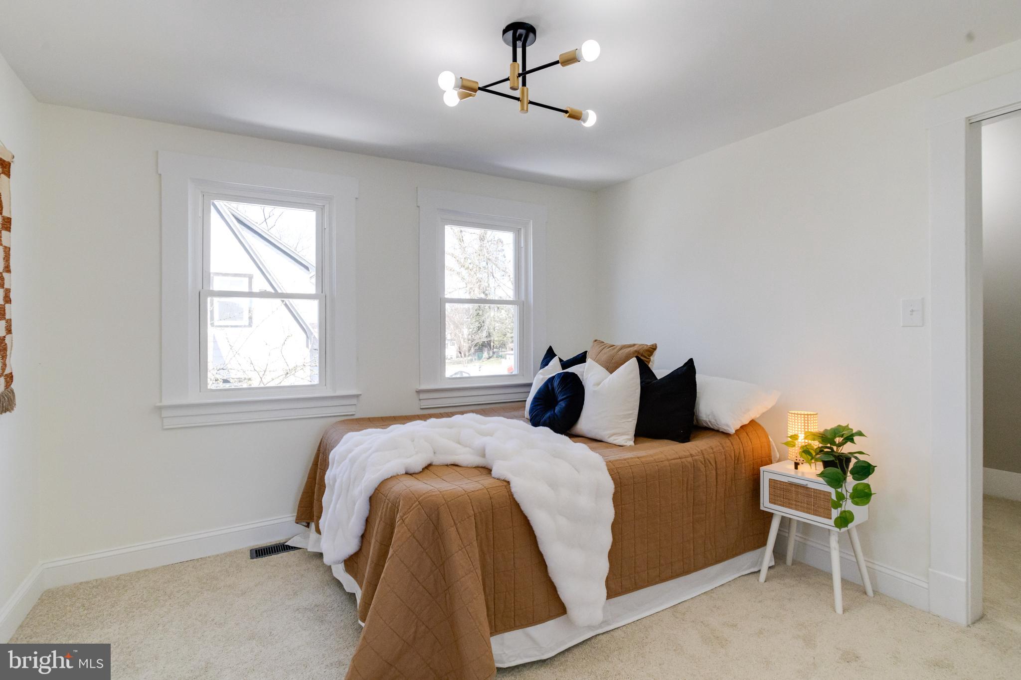 1729 Winans Avenue Halethorpe, MD 21227 - Photo 23 of 40 a bed room with a bed and a chandelier