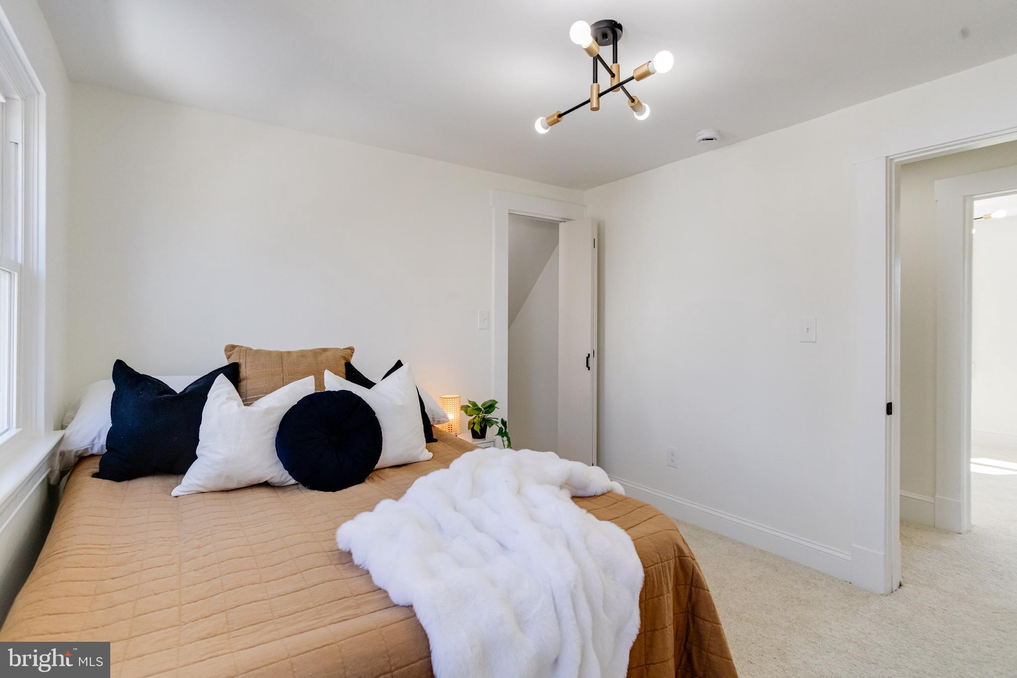 1729 Winans Avenue Halethorpe, MD 21227 - Photo 24 of 40 a bedroom with a bed and a chandelier