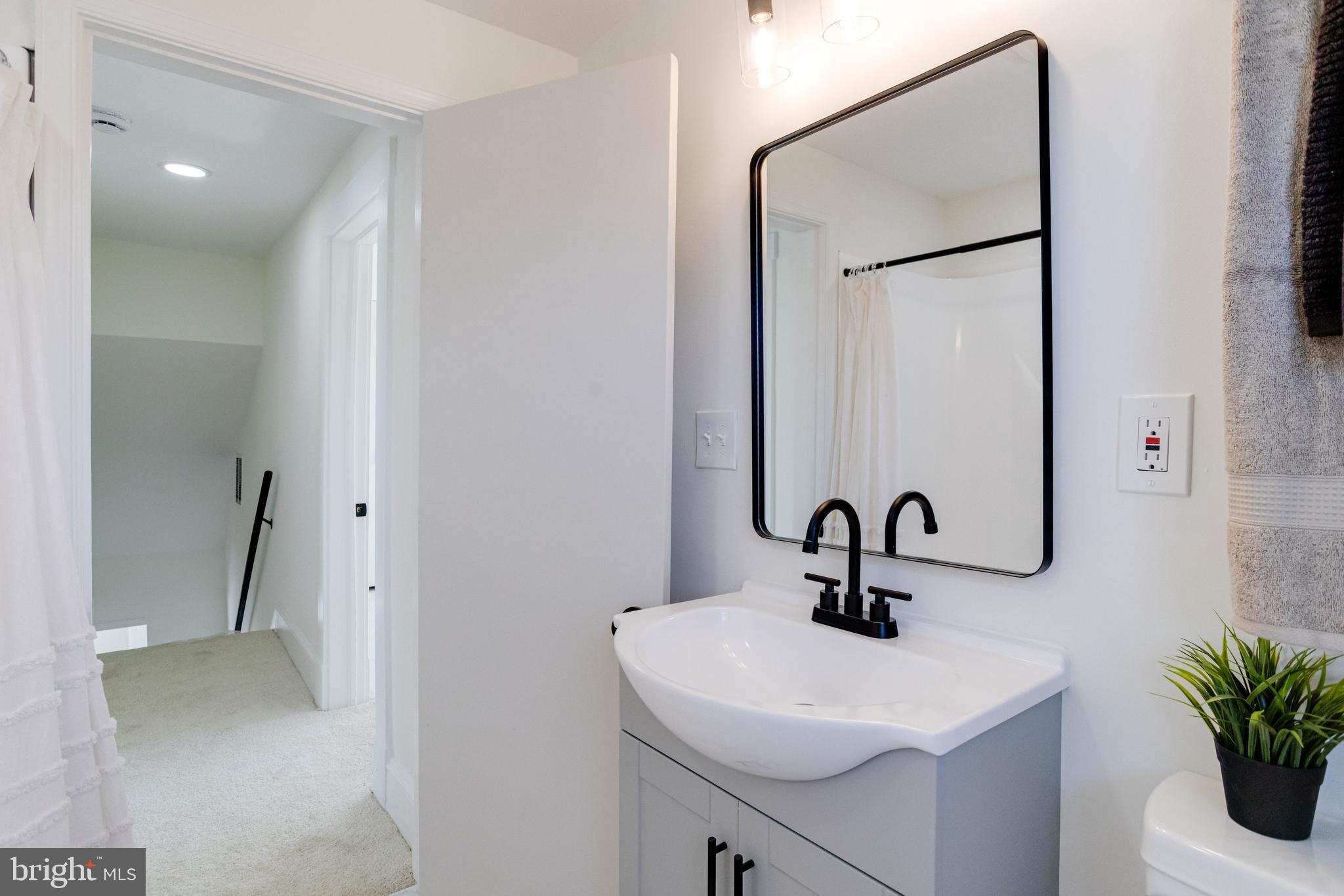 1729 Winans Avenue Halethorpe, MD 21227 - Photo 30 of 40 a bathroom with a sink a mirror and vanity