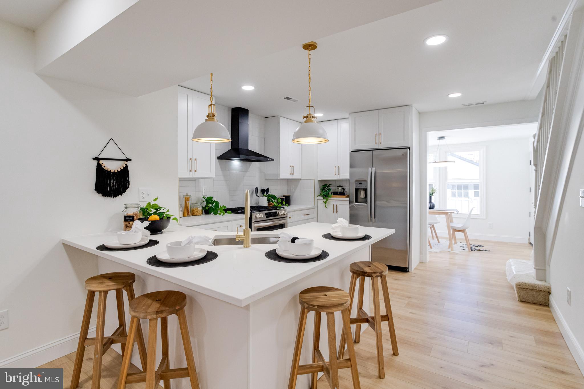 1729 Winans Avenue Halethorpe, MD 21227 - Photo 8 of 40 a kitchen with stainless steel appliances lots of white furniture a refrigerator and a view of living room