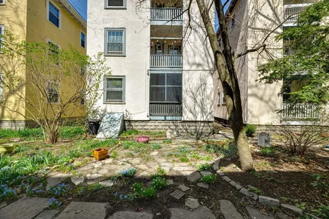 a picture of a bench in front of a wall
