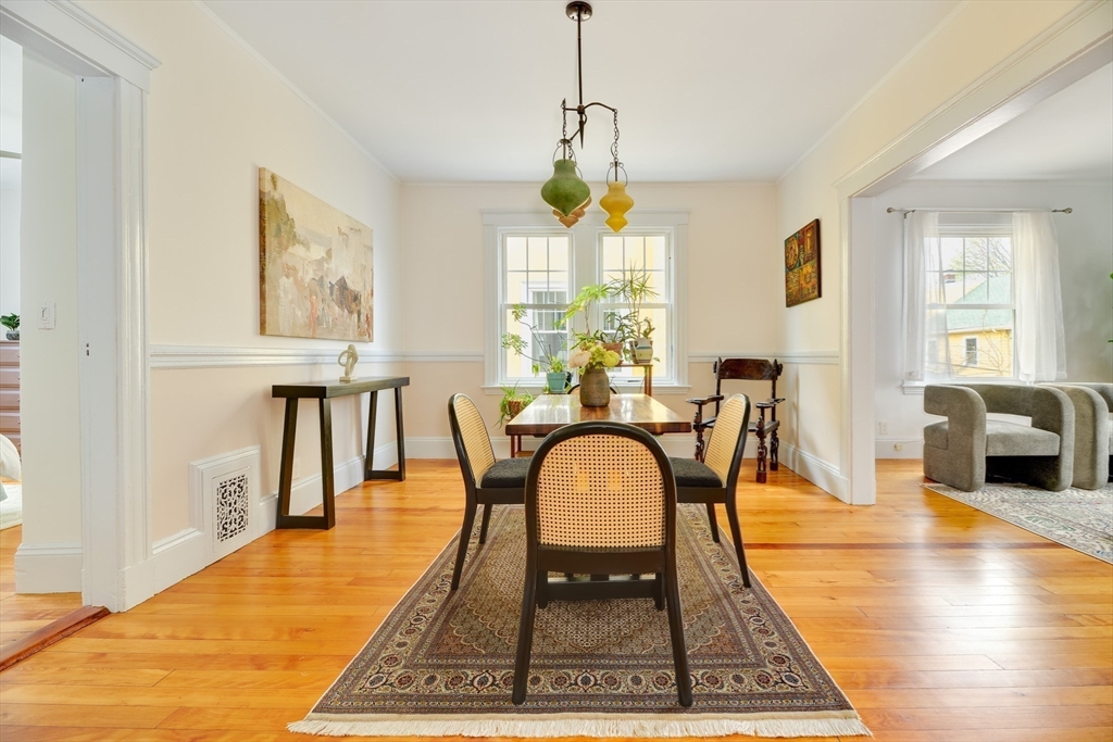 48 Crescent Street, Unit 2 Cambridge, MA 02138 - Photo 4 of 17 a dining room with wooden floor and large windows
