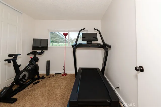 a room with gym equipment and a mirror
