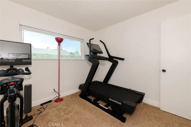 a room with gym equipment and a window