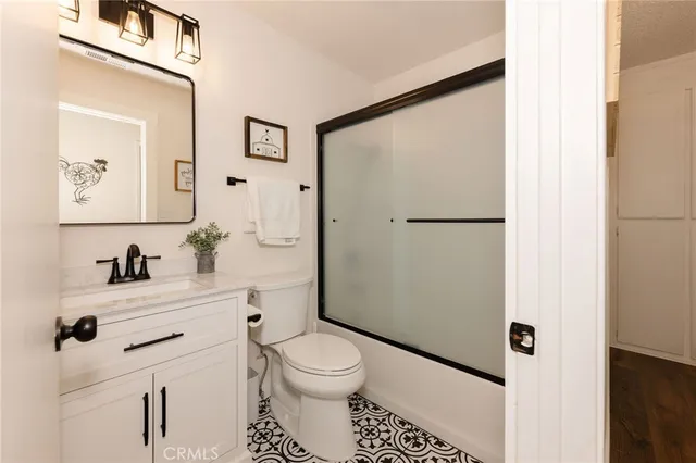 a white toilet sitting next to a bathroom sink