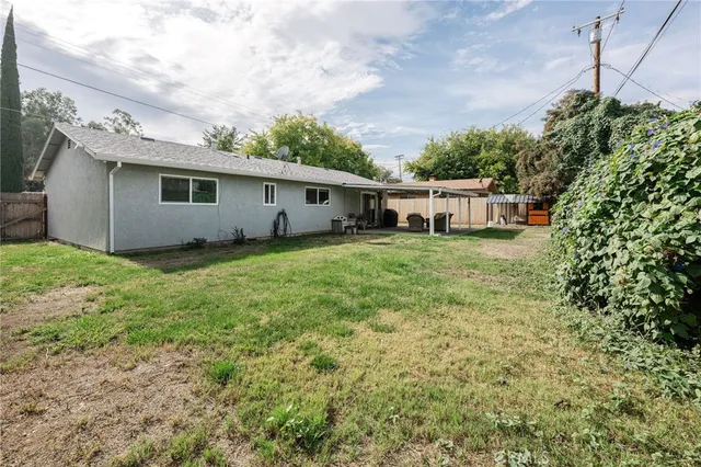 a view of a house with yard and sitting area