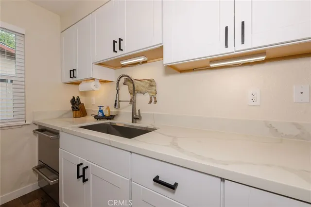 a sink with a vanity and mirror