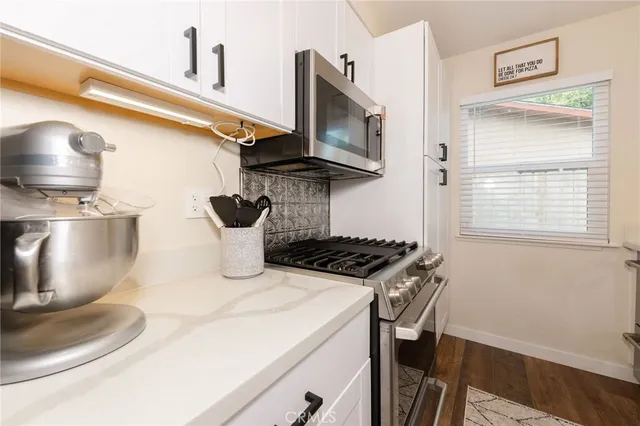 a kitchen with a stove and a microwave