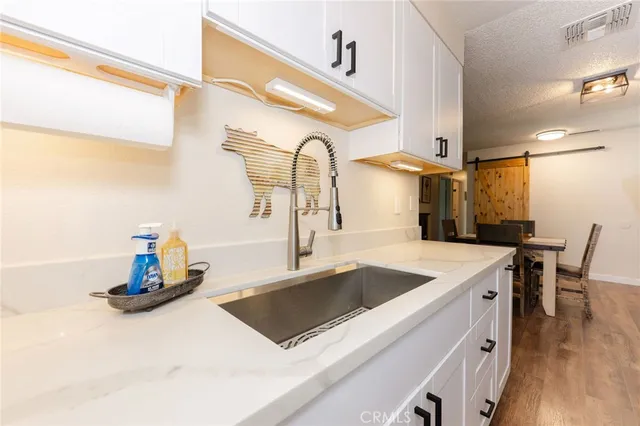 a kitchen with a sink a counter and appliances