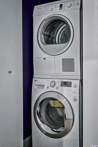 a view of a kitchen with stainless steel appliances granite countertop a stove and wooden floor