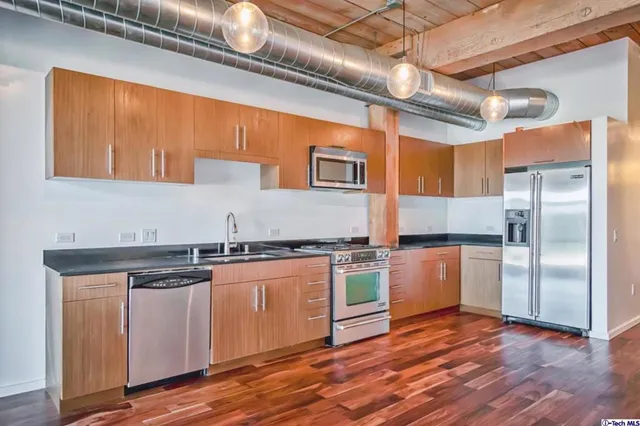 a view of a room with wooden floor and windows