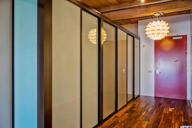 a view of a hallway with wooden floor