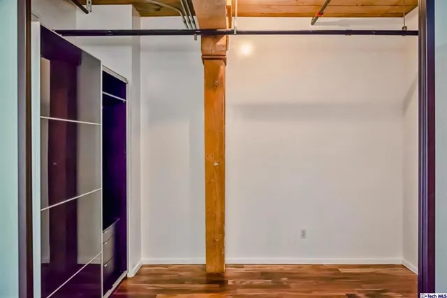 a view of a room with wooden floor and cabinet