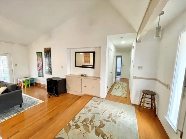 a spacious bedroom with a bed a couch and dresser