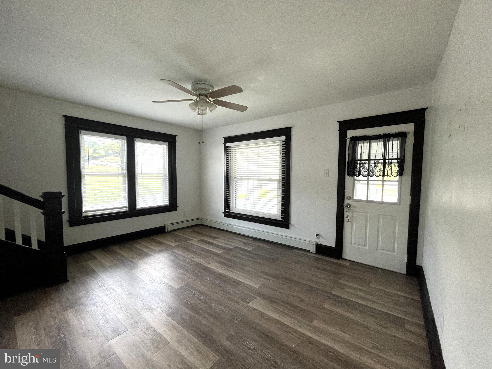 1660 Shimerville Road Emmaus, PA 18049 - Photo 5 of 26 a view of an empty room with wooden floor and a window