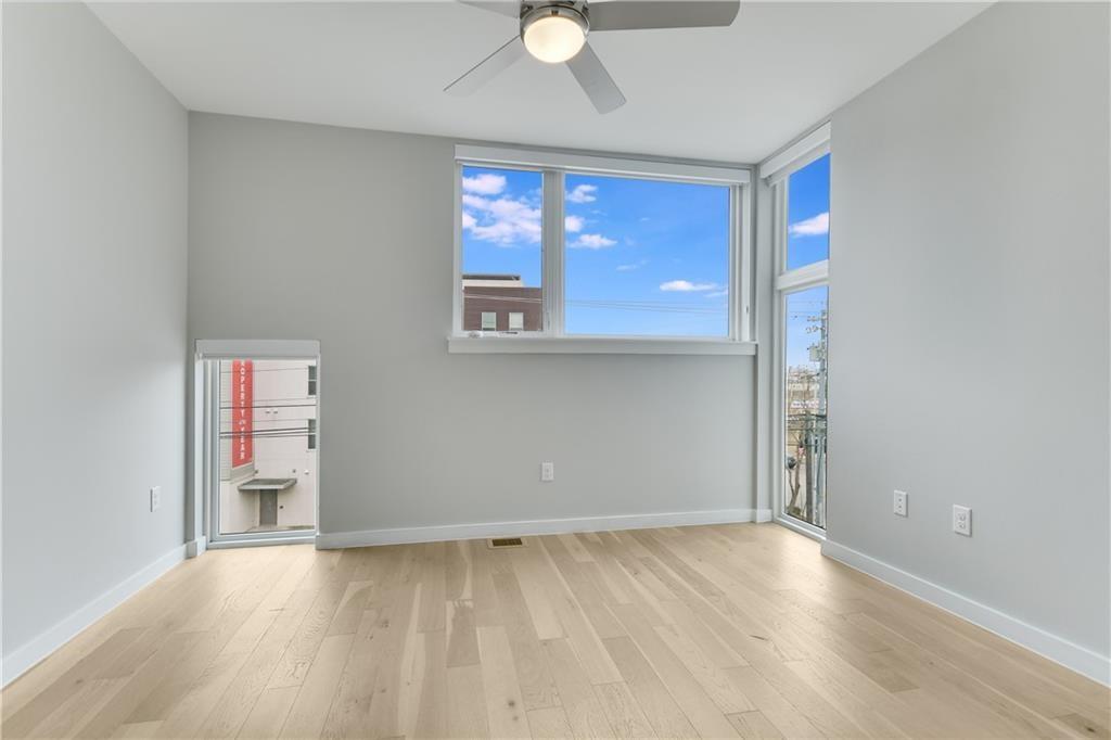 2002 East 7th Street, Unit 212 Austin, TX 78702 - Photo 12 of 23 an empty room with wooden floor and windows