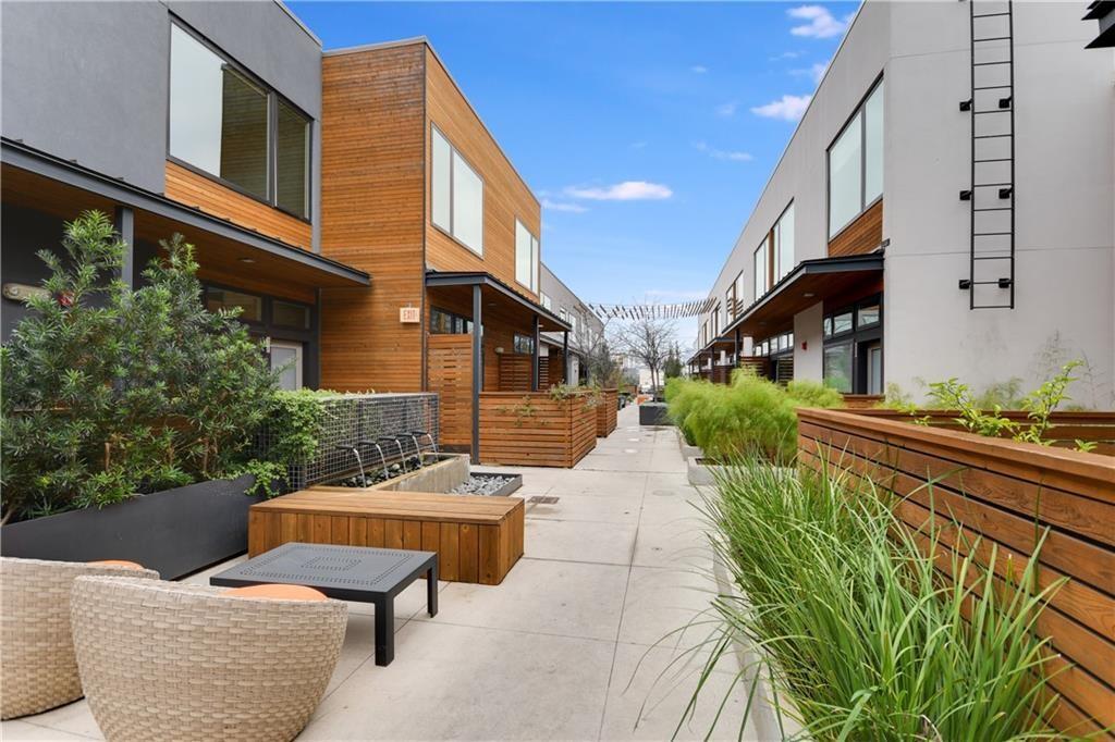 2002 East 7th Street, Unit 212 Austin, TX 78702 - Photo 13 of 23 a view of a patio with couches table and chairs and potted plants