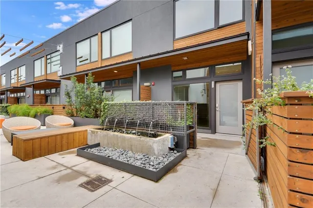a view of a house with backyard and sitting area