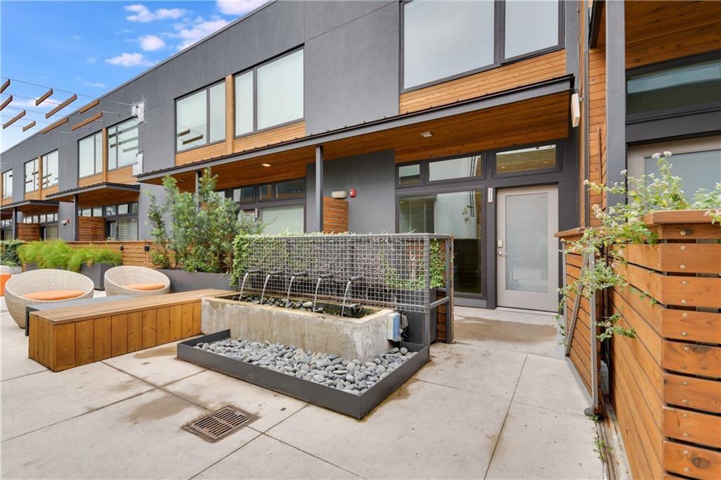 2002 East 7th Street, Unit 212 Austin, TX 78702 - Photo 2 of 23 a view of a house with backyard and sitting area
