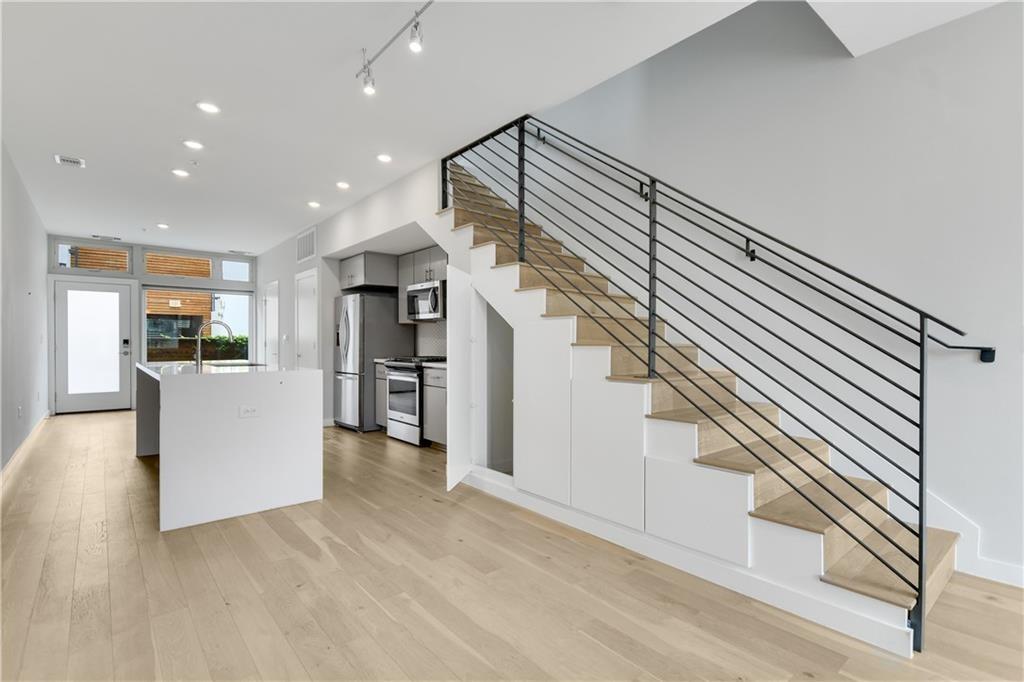 2002 East 7th Street, Unit 212 Austin, TX 78702 - Photo 4 of 23 a view of kitchen with furniture and wooden floor