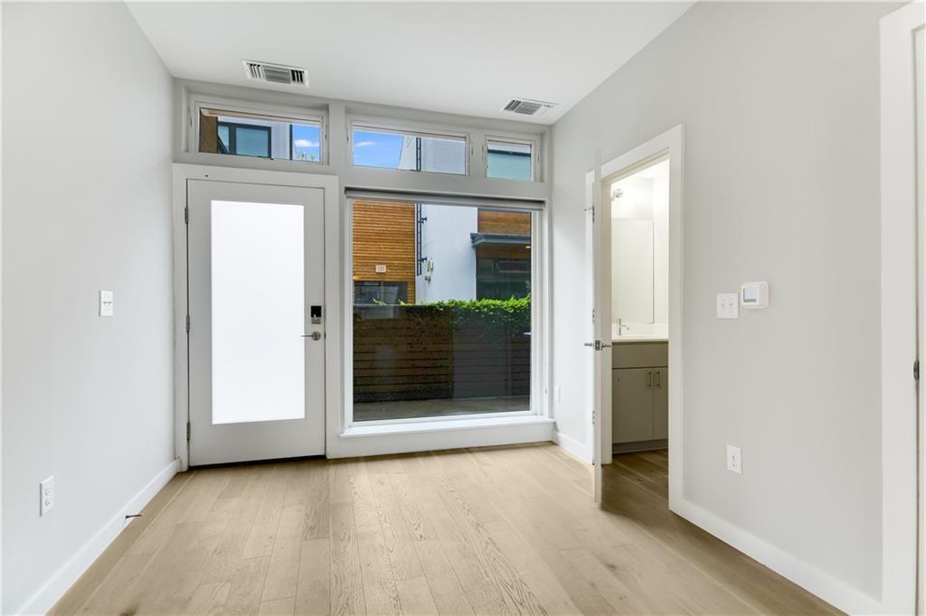 2002 East 7th Street, Unit 212 Austin, TX 78702 - Photo 5 of 23 an empty room with windows and entrance