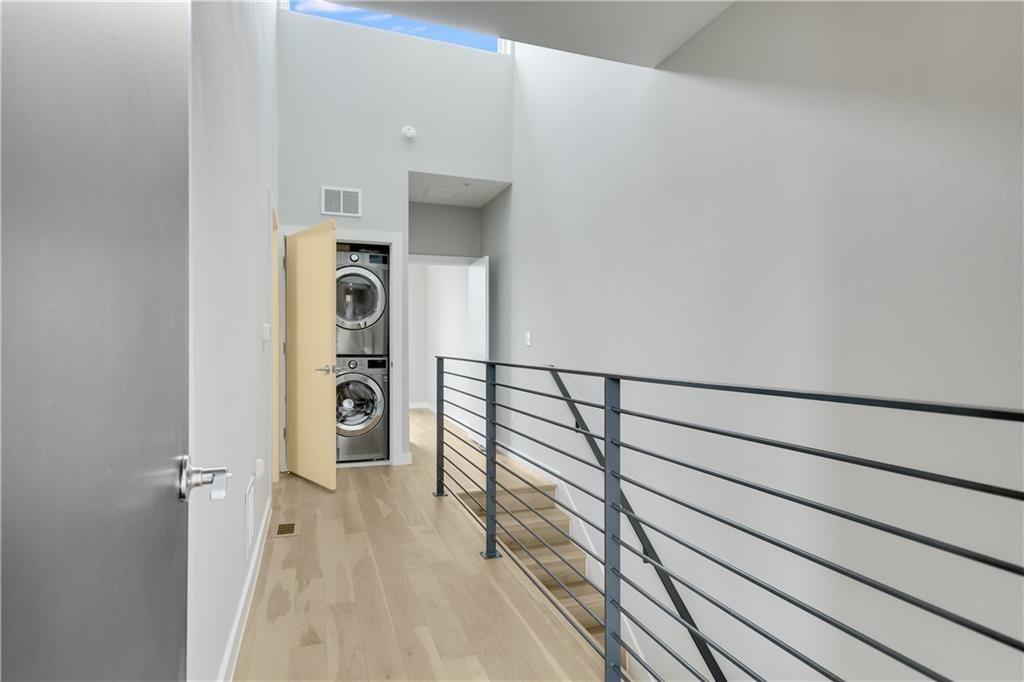 2002 East 7th Street, Unit 212 Austin, TX 78702 - Photo 9 of 23 a view of a hallway with wooden floor and staircase