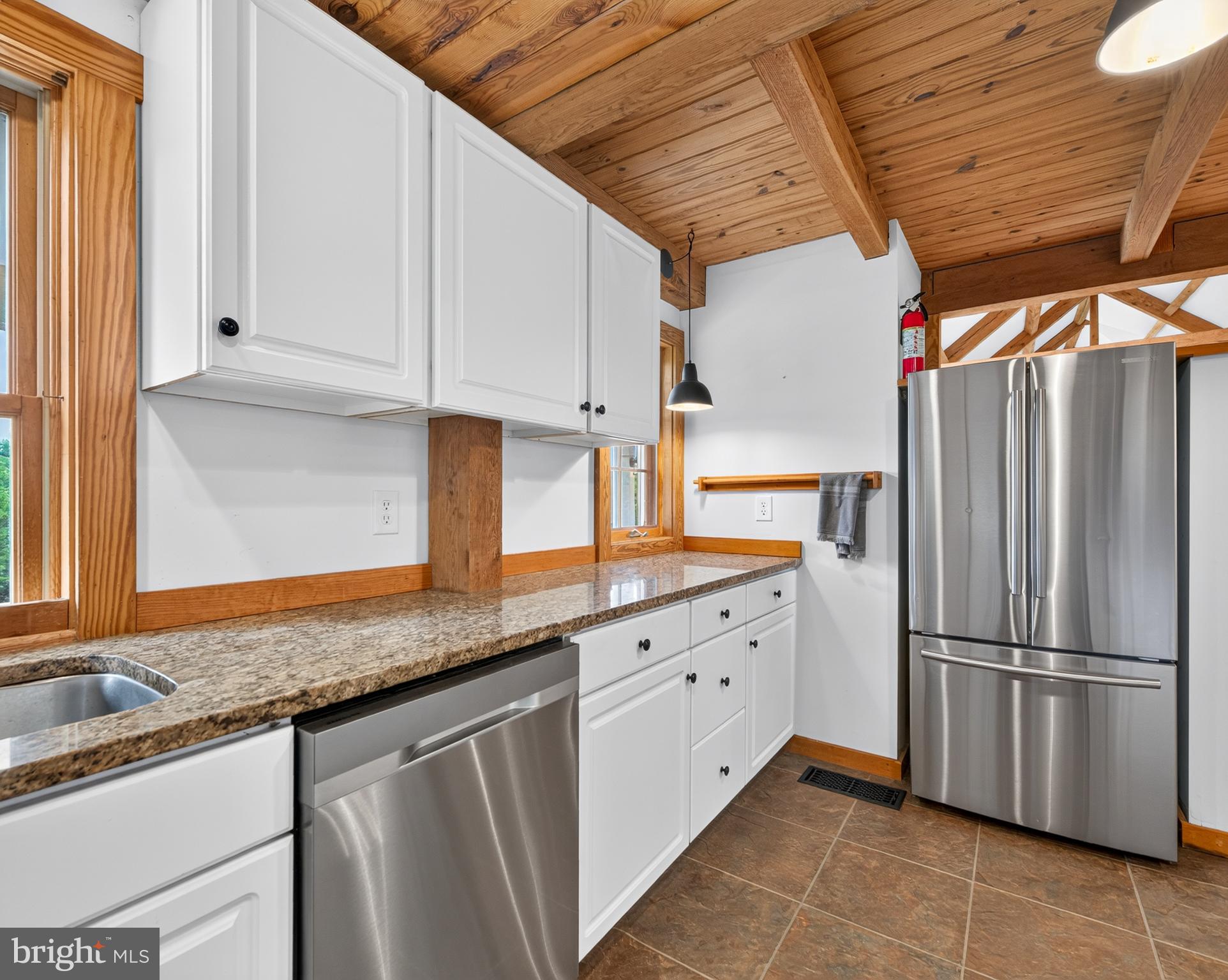 4028 South F T Valley Road Etlan, VA 22719 - Photo 49 of 101 a kitchen with granite countertop a sink stainless steel appliances a counter top space and cabinets