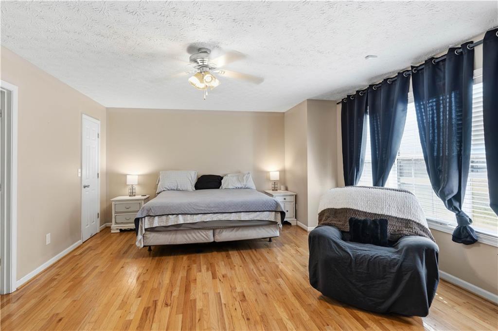 7540 County Line Road Lula, GA 30554 - Photo 11 of 62 a spacious bedroom with a bed and a couch