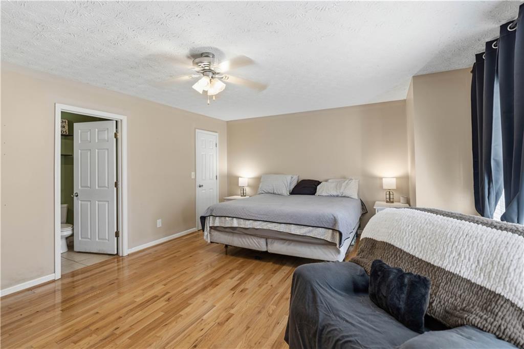 7540 County Line Road Lula, GA 30554 - Photo 12 of 62 a bedroom with a bed and wooden floor