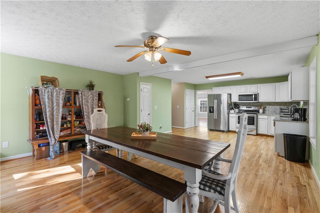 7540 County Line Road Lula, GA 30554 - Photo 18 of 62 a living room with stainless steel appliances kitchen island granite countertop furniture and a kitchen view