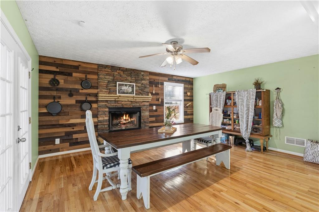 7540 County Line Road Lula, GA 30554 - Photo 22 of 62 a living room with furniture a flat screen tv and a fireplace