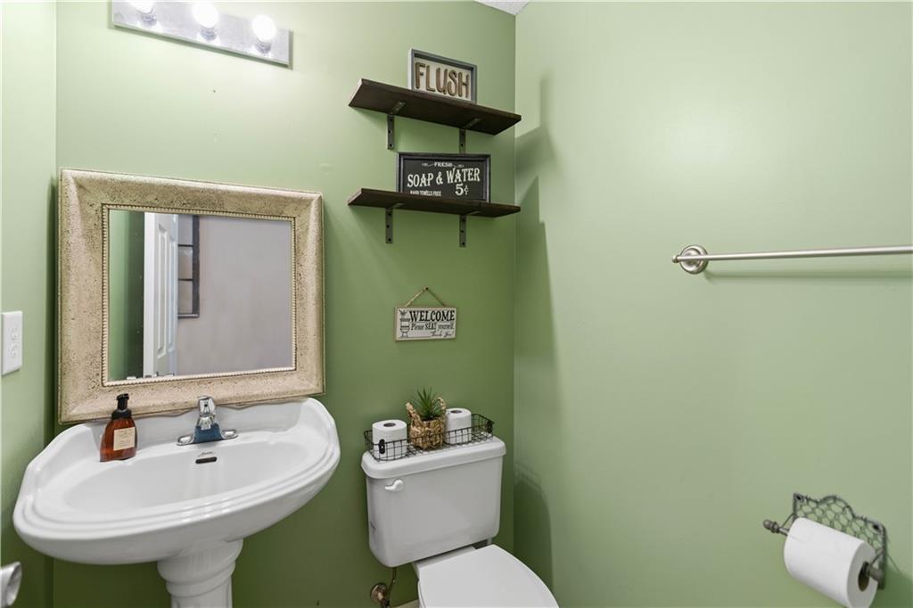 7540 County Line Road Lula, GA 30554 - Photo 27 of 62 a bathroom with a sink mirror and toilet