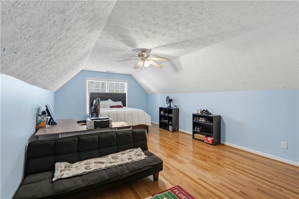 7540 County Line Road Lula, GA 30554 - Photo 33 of 62 a bed room with furniture and a chandelier