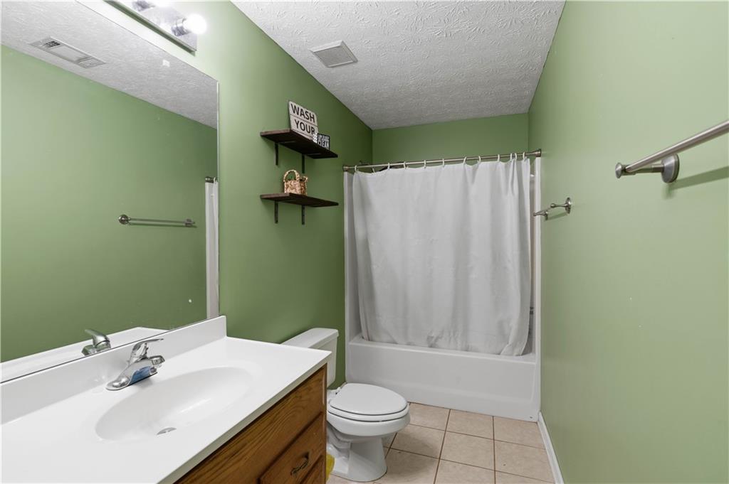 7540 County Line Road Lula, GA 30554 - Photo 36 of 62 a bathroom with a sink toilet and shower
