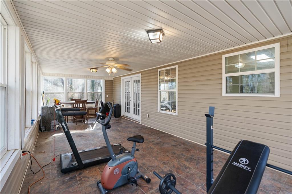 7540 County Line Road Lula, GA 30554 - Photo 41 of 62 a living room with furniture a window and gym equipment
