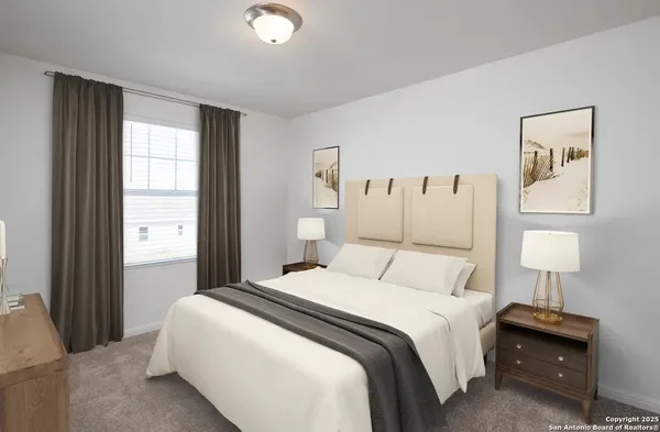 a bedroom with a bed and a lamp