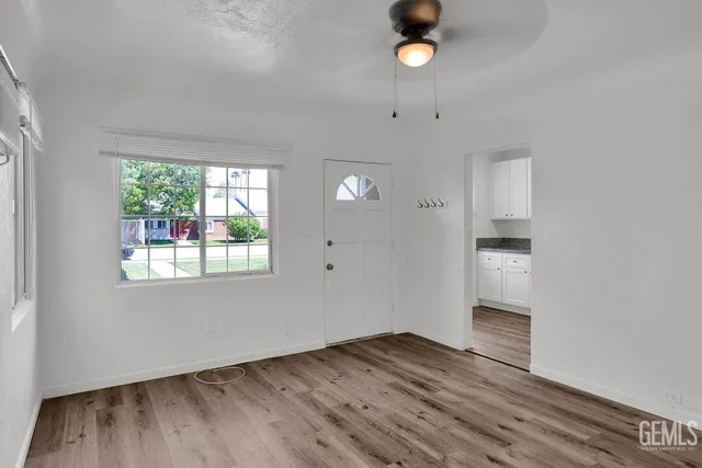 wooden floor in an empty room with a window