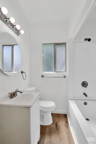 a bathroom with a sink a toilet and bathtub