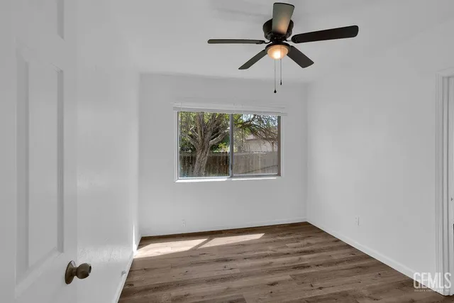 a view of room with a window and wooden floor