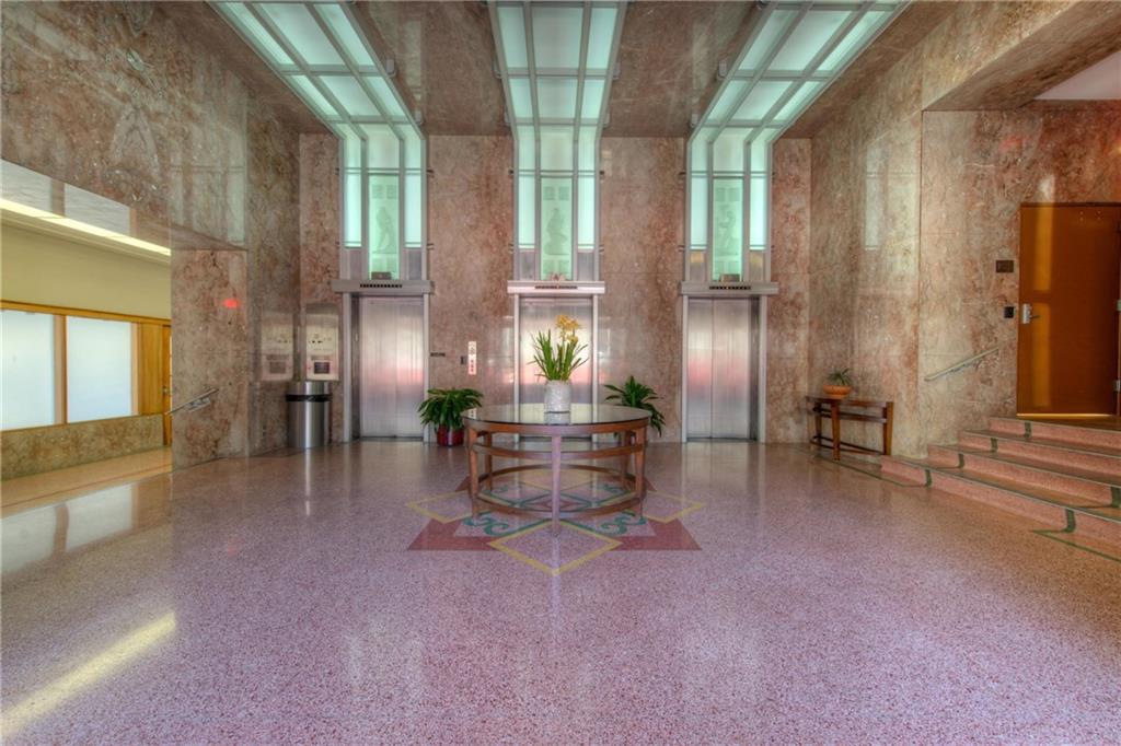 710 Colorado Street, Unit 6E Austin, TX 78701 - Photo 19 of 24 Elegant lobby with rich marble walls and gleaming terrazzo flooring provides a grand welcome.