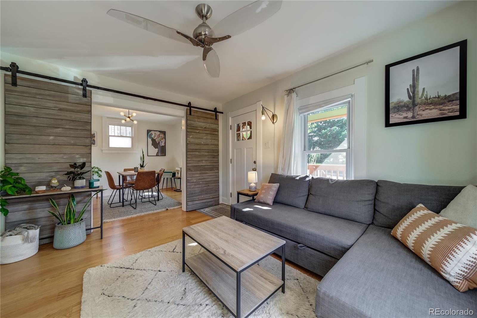 5129 Zuni Street Denver, CO 80221 - Photo 11 of 40 a living room with furniture and a large window