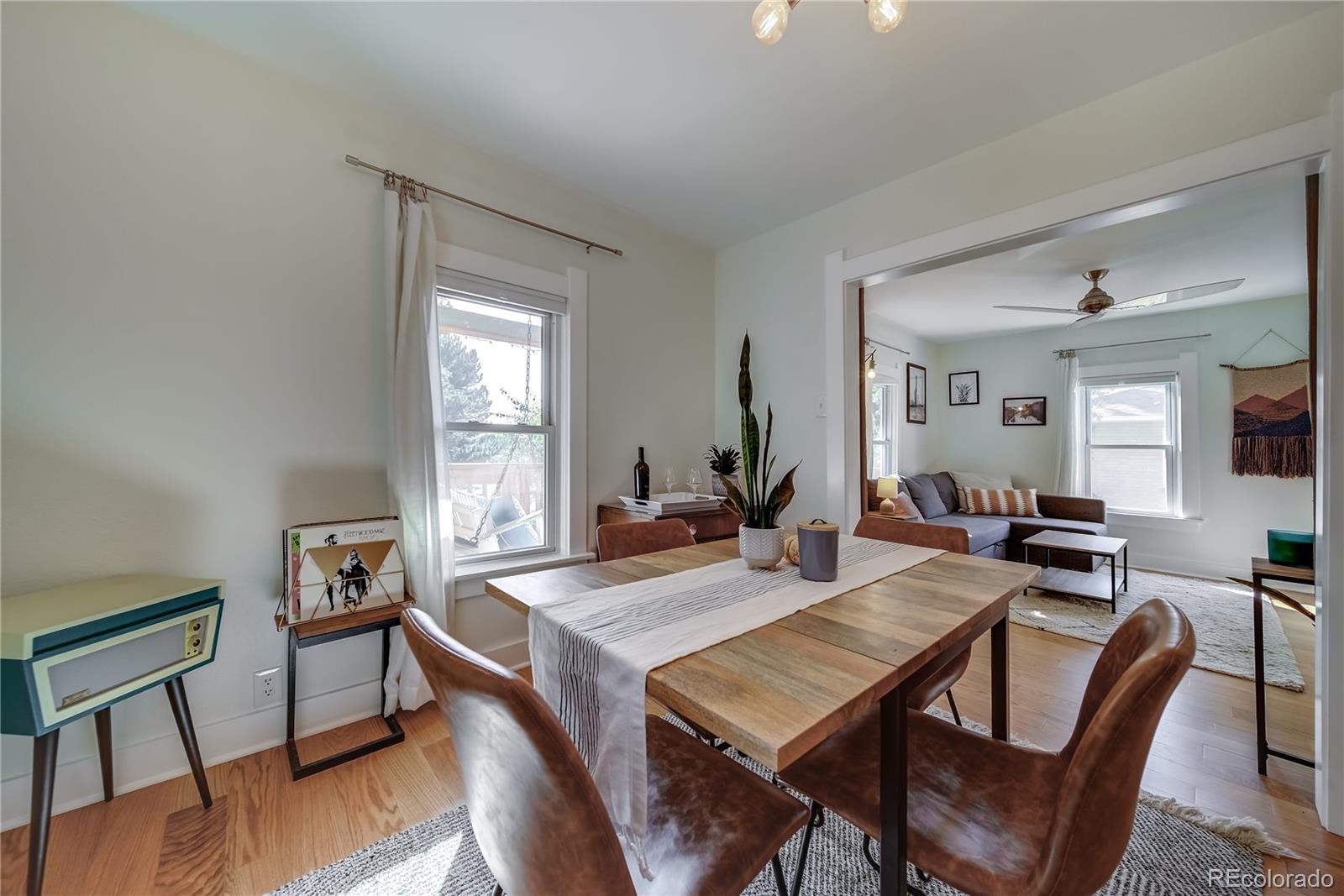5129 Zuni Street Denver, CO 80221 - Photo 14 of 40 a view of a dining room with furniture window and wooden floor
