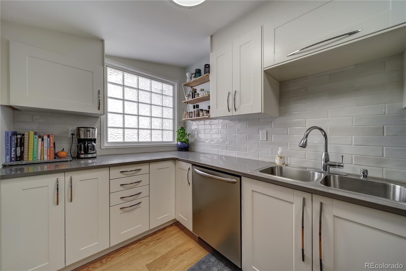 5129 Zuni Street Denver, CO 80221 - Photo 19 of 40 a kitchen with sink a window and cabinets